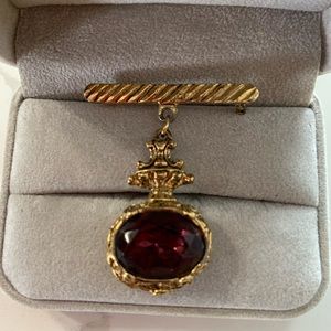 Vintage costume jewelry gold colored bar and pendant.